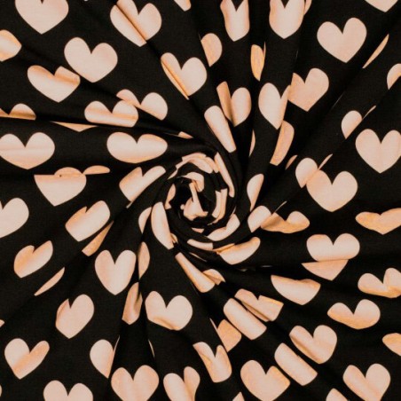Tissu jersey coeur rose poudré fond noir