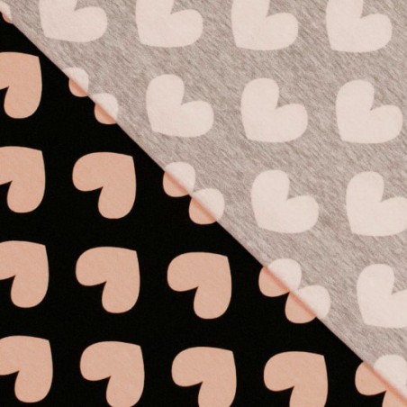 Tissu jersey coeur rose poudré fond noir