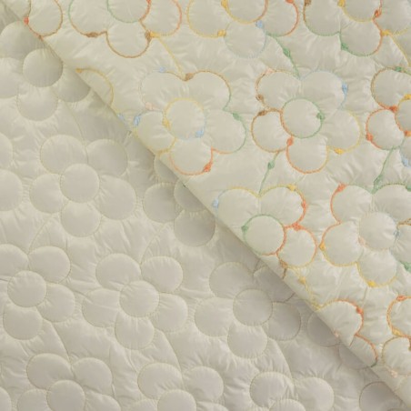 Tissu matelassé doudoune brodé fleur fond écru