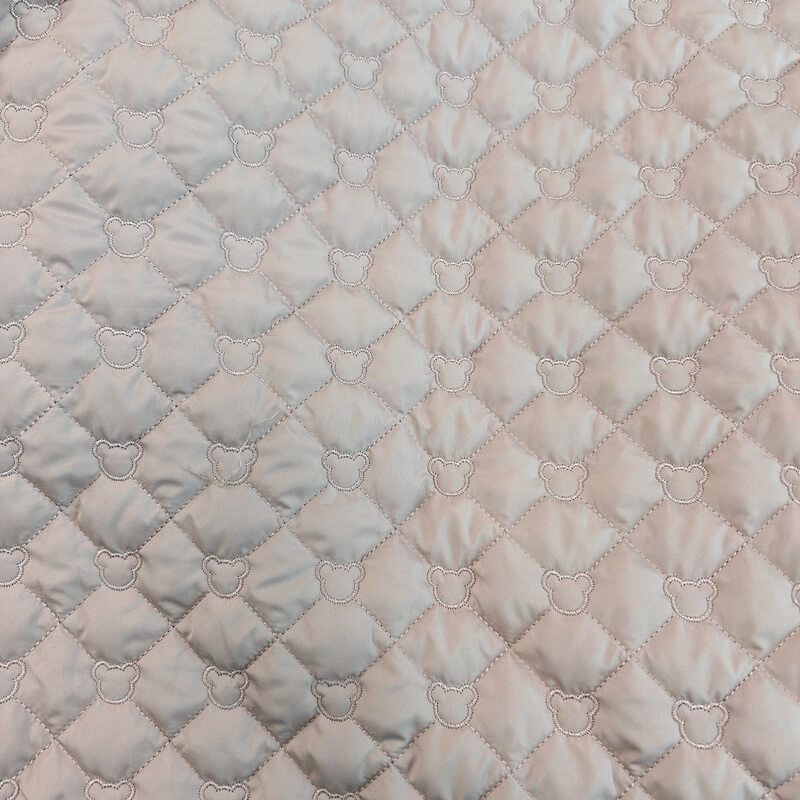 Tissu matelassé tête d'ours beige rosé Tissu matelassé tête d'ours beige rosé